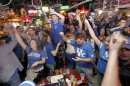 University of Kentucky fans celebrate after the final horn on Monday, April 2, 2012 at Lynagh's Irish Pub & Grill at University Plaza on Woodland Ave. in Lexington, Ky. University of Kentucky fans cheered on UK to victory in the Final Four championship game as they watched the Wildcats defeat Kansas 67-59. (AP Photo/David Perry,Lexington-Herald Leader)
