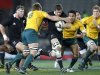 New Zealand's Richie McCaw looks to burst through a tackle by Australia's Ben McCalman, left, during their Tri Nations and Bledisloe cup rugby match at Eden Park in Auckland, New Zealand, Saturday, Aug. 6, 2011. (AP Photo/NZPA, Wayne Drought) NEW ZEALAND OUT