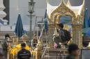 Police investigate the scene around the Erawan Shrine the morning after an explosion in Bangkok,Thailand, Tuesday, Aug. 18, 2015. A bomb exploded Monday within a central Bangkok shrine that is among the city's most popular tourist spots, killing a number of people and injuring others, police said. (AP Photo/Mark Baker)