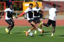 Ghana's Michael Essien, Kevin Prince Boateng and Andre Ayew, from left to centre, challenge for the ball during a training session in Brasilia, Brazil, Wednesday, June 25, 2014. Ghana will play Portugal in group G of the 2014 soccer World Cup on June 26. (AP Photo/Paulo Duarte)