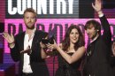 FILE - In this Nov. 20, 2011, file photo Lady Antebellum musical group members from left, Charles Kelley, Hillary Scott and Dave Haywood, accept the award for country band, duo or group at the 39th Annual American Music Awards on in Los Angeles. Students from the wrecked school awaited word Tuesday, March 20, 2012, about whether on online campaign supported by other schools in their state and beyond will land them a prom-night performance by Grammy-winning country trio Lady Antebellum. (AP Photo/Matt Sayles, File)