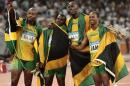 FILE - In this Friday, Aug. 22, 2008 file photo, Jamaica's gold medal winning relay team, Usain Bolt, 2nd right, Michael Frater, right, Asafa Powell, left, and Nesta Carter celebrate after the men's 4x100-meter relay final during the athletics competitions in the National Stadium at the Beijing 2008 Olympics in Beijing. Usain Bolt has been stripped of one of his nine Olympic gold medals, Wednesday Jan. 25, 2017, in a doping case involving teammate Nesta Carter. (AP Photo/Itsuo Inouye, File)
