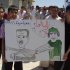 In this citizen journalism image made on a mobile phone and provided by Shaam News Network, anti-Syrian President Bashar Assad protesters, hold a cartoon placard depicting Moammar Gadhafi, right, and Syrian President Bashar Assad, left, with Arabic words read:"step back," during a demonstration against the Syrian regime, at Maaret Harma village, in Edlib province, Syria, on Friday Aug. 26, 2011. Syrian security forces killed at least two people as tens of thousands of anti-government protesters flooded the streets on the last Friday of the holy month of Ramadan, a time that many activists hoped would become a turning point in the uprising. (AP Photo/Shaam News Network) EDITORIAL USE ONLY, NO SALES, THE ASSOCIATED PRESS IS UNABLE TO INDEPENDENTLY VERIFY THE AUTHENTICITY, CONTENT, LOCATION OR DATE OF THIS HANDOUT PHOTO