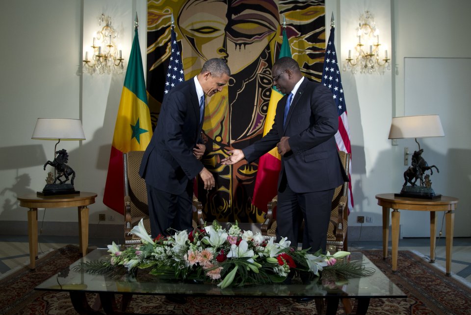 Senegalese President Macky Sall, right, gestures for U.S. President Barack Obama to sit during a bilateral meeting at the Presidential Palace on Thursday, June 27, 2013, in Dakar, Senegal. President Obama landed in Senegal Wednesday night to kick off a weeklong trip to Africa, a three-country visit aimed at overcoming disappointment on the continent over the first black U.S. president's lack of personal engagement during his first term. (AP Photo/Evan Vucci)