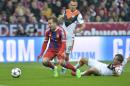 Bayern's Mario Goetze, left, falls after a could by Shakhtar's Olexandr Kucher, right, as Shakhtar's Vyacheslav Shevchuk, back looks on during the Champions League round of 16 second leg soccer match between Bayern Munich and Shakhtar Donetsk Wednesday, March 11, 2015 in Munich, southern Germany. (AP Photo/Kerstin Joensson)