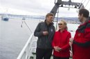 U.S. Secretary of State Hillary Clinton talks to Jarle Aarbakke, rector of the Uni of Tromso, and Jan-Gunnar Winther, director of the Norwegian Polar Institute, during a tour of a fjord off Tromso