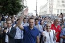 Russian opposition leader Alexei Navalny makes his way to the city's election commission office to get registered as a mayoral election candidate in Moscow