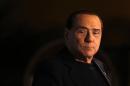 Former Prime Minister Silvio Berlusconi looks on during a speech from the stage in downtown Rome