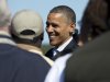 President Barack Obama greets people on the tarmac as he arrives at Newport News Williamsburg International Airport on Air Force One, Saturday, Oct. 13, 2012, in Williamsburg, Va. (AP Photo/Carolyn Kaster)