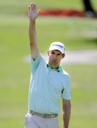 Padraig Harrington, of Ireland, waves after making a 74-foot birdie putt on the 17th hole during the first round of the Transitions golf tournament Thursday, March 15, 2012, in Palm Harbor, Fla. Harrington finished the day at 10-under-par 61. (AP Photo/Chris O'Meara)
