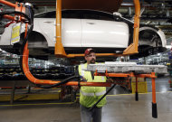 <p>               In this Dec. 14, 2011 photo, line worker Jeff Danes demonstrates moving a battery charger for a Ford Focus on the assembly line at the Ford Michigan Assembly plant in Wayne, Mich. The final weeks of 2011 were the economy's strongest since it appeared to be slipping toward recession in late spring. (AP Photo/Paul Sancya)