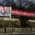 A North Korean soldier stands beneath roadside propaganda which reads "Let's Uphold the Military First Revolutionary Leadership of the Great Comrade Kim Jong Un With Loyalty" in Pyongyang on Tuesday, April 9, 2013. (AP Photo/David Guttenfelder)