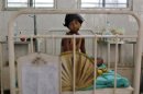 A girl, who fell sick after consuming contaminated meals given to children at a school on Tuesday, rests inside a hospital in Patna