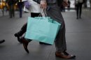 A shopper carries bags from Tiffany & Co. jewelers along 5th Avenue in New York City
