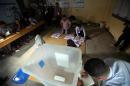 Election commission officials count votes at a polling station in the capital Baghdad on April 30, 2014