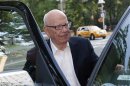 News Corp Chief Executive and Chairman Murdoch enters his vehicle as he leaves his home in New York
