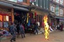 Nepalese policemen rush as a Tibetan monk burns after he set himself on fire in Katmandu, Nepal, Wednesday, Feb. 13, 2013. The Tibetan monk doused himself with gasoline and set himself on fire in Nepal's capital Wednesday in what is believed to be the latest self-immolation to protest Chinese rule in Tibet. Nearly 100 Tibetan monks, nuns and lay people have set themselves on fire in various countries, mostly in ethnic Tibetan areas inside China, since 2009.( AP Photo)