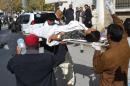 Pakistani volunteers carry an injured polio female health worker to a hospital in Quetta on November 26, 2014
