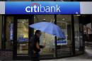 FILE - In this Jan. 14, 2014 file photo, a person walks past a Citibank location in Philadelphia. Citigroup reduced its 2013 earnings by $235 million on Friday, Feb. 28, 2014, saying it was a victim of fraud committed by a Mexican oil services company to secure hundreds of millions of dollars in short-term loans. (AP Photo/Matt Rourke, File)