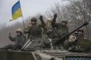 Members of the Ukrainian armed forces ride an armoured personnel carrier near Debaltseve