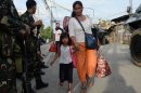Residents affected by the standoff between Muslim gunmen and army troops evacuate Zamboanga City, September 10, 2013