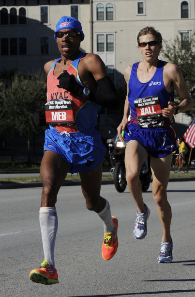 Meb Keflezighi, left, and Ryan Hall compete on the final lap of the U.S. Olympic marathon trials Saturday, Jan. 14, 2012, in Houston. Keflezighi won the men's trial to qualify for his third Games along with hall who came in second. (AP Photo/Pat Sullivan)