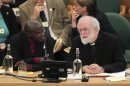 Dr John Sentamu, Archbishop of York, left, and Dr Rowan Williams, the outgoing Archbishop of Canterbury, speak during a meeting of the General Synod of the Church of England, at Church House in central London, Wednesday Nov. 21, 2012. The leader of the Church of England says it has much explaining to do following its failure to vote to allow women to serve as bishops. (AP Photo/Yui Mok, Pool)