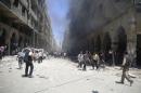 Smoke rises due to what activists claimed was shelling by forces loyal to Syrian President al-Assad in a market in central Duma