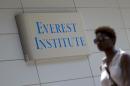 FILE - In this July 8, 2014 file photo, a woman walks past the Everest Institute in Silver Spring, Md. Corinthian Colleges, which owns Everest, Heald College and WyoTech schools, is being sued by the federal Consumer Financial Protection Bureau for what it calls a 