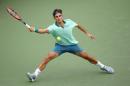 Roger Federer of Switzerland hits a return in the win over David Ferrer of Spain during the finals of the Western & Southern Open on August 17, 2014 at the Linder Family Tennis Center in Cincinnati, Ohio