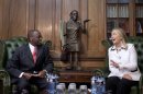 FILE - In this Saturday, Aug. 4, 2012 file photo, U.S. Secretary of State Hillary Rodham Clinton, right, meets Chief Justice Willy Mutunga at the Supreme Court of Kenya, in Nairobi, Kenya. Mutunga is making an extraordinary public statement that he will not be cowed by threats and harassment ahead of the country's March 4 election, after receiving a threatening letter warning of dire consequences if the courts rule against the eligibility of two leaders who are facing trial at the International Criminal Court. (AP Photo/Jacquelyn Martin, Pool, File)