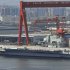 In this photo taken on Aug. 6, 2011, a Chinese aircraft carrier, which had been under refurbishment, is docked at Dalian port in in northeast Liaoning province. China's first aircraft carrier started sea trials Wednesday, Aug. 10, 2011, a step that will likely boost concerns about the country's naval ambitions amid sea territorial disputes. (AP Photo/Color China Photo) CHINA OUT