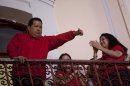 Venezuela's President Hugo Chavez greets his supporters from the Miraflores presidential palace balcony in Caracas, Venezuela, Sunday, Oct. 7, 2012. Chavez won re-election and a new endorsement of his socialist project Sunday, surviving his closest race yet after a bitter campaign against opposition candidate Henrique Capriles.(AP Photo/Rodrigo Abd)