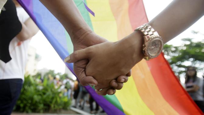 Filipino LGBTs (Lesbians Gays Bisexual and Transgenders) hold hands as they gather for a Gay Pride rally Saturday, June 27, 2015 in Mania, Philippines to push for LGBT rights and to celebrate the U.S. Supreme Court decision recognizing gay marriages in all U.S. states as a victory for their cause. The rally was scheduled to commemorate the 1969 demonstrations in New York City that started the gay rights movement around the world. Jonas Bagas, executive director of the pro-LGBT rights group TLF Share, said the U.S. court ruling “will reverberate in other corners of the world.” (AP Photo/Bullit Marquez)