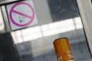 Public ashtray is pictured in front of a sign marking a no-smoking zone in Vienna