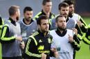 Spain's Cesc Fabregas, left center, and Jordi Alba, right center, run with their teammates during a training session at the Atletico Paranaense training center in Curitiba, Brazil, Monday, June 9, 2014. Spain will play in group B of the Brazil 2014 World Cup. (AP Photo/Manu Fernandez)