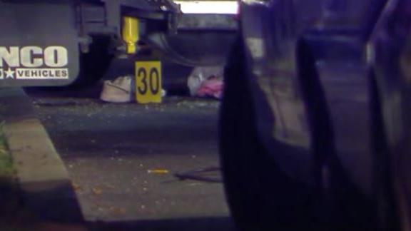 In this Dec. 30, 2014, photo taken from a video provided by WTXF Television, authorities investigate the scene after a man was shot and killed by police after he tried to use his car to run down officers seeking to arrest him in Upper Darby, Pa. The authorities said that the man had posted an online video threatening to kill police and FBI agents. (AP Photo/WTXF Television) MANDATORY CREDIT