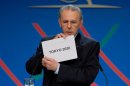 IOC President Jacques Rogge shows the card reading Tokyo in Buenos Aires on September 7, 2013