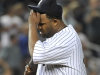 New York Yankees starting pitcher CC Sabathia wipes his brows after Seattle Mariners' Brendan Ryan hit a single to break up a perfect game in the seventh inning of a baseball game Tuesday, July 26, 2011, at Yankee Stadium in New York. (AP Photo/Kathy Kmonicek)