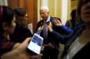 McCain speaks with a reporter after the weekly Republican caucus luncheon at the U.S. Capitol in Washington
