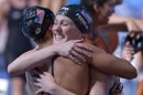 United States' Missy Franklin, right, embraces Megan Romano after she anchored the US team to the gold medal in the Women's 4x100m freestyle relay final at the FINA Swimming World Championships in Barcelona, Spain, Sunday, July 28, 2013.(AP Photo/Manu Fernandez)