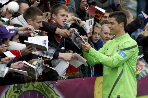Portugal's Ronaldo signs autographs for Polish soccer fans after a training session ahead of the Euro 2012 soccer tournament at Opalenica stadium near Poznan