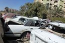 Destroyed vehicles are seen at the site of a car bomb