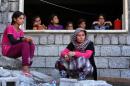 Iraqi Yazidi women who fled the violence in the northern Iraqi town of Sinjar, sit at a school where they are taking shelter in the Kurdish city of Dohuk in Iraq's autonomous Kurdistan region, on August 5, 2014