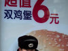A security guard stands in front of a hamburger advertisement outside a fast food restaurant in Beijing, China, Thursday, Feb. 9, 2012. China's inflation rebounded in January as food prices soared, renewing pressure on the communist government to control surging living costs while it tries to boost slowing economic growth. (AP Photo/Alexander F. Yuan)