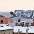 Snow covers the rooftops of the houses overlooking the harbour of the Tuscan island of Giglio, Italy, Saturday, Feb. 11, 2012, as the grounded Costa Concordia cruise liner still lays stricken in background. The Concordia ran aground on Jan. 13 after the captain deviated from his planned route and gashed the hull of the ship on a submerged reef.  (AP Photo/Paolo Fanciulli)