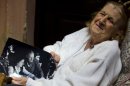 In this April 12, 2013 photo, Clelia Luro shows a picture of herself with her late husband, Jeronimo Podesta, a former bishop of Avellaneda, at her home in Buenos Aires, Argentina. Luro, whose romance with the former bishop and eventual marriage became a major scandal in the 1960s, is such a close friend with Pope Francis that he called her every Sunday when he was Argentina's leading cardinal. She's convinced that Pope Francis will eventually lead the global church to end mandatory priestly celibacy, a requirement she says 