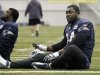 New England Patriots defensive end Shaun Ellis, right, stretches during practice on Wednesday, Feb. 1, 2012, in Indianapolis. The Patriots are scheduled to face the New York Giants in NFL football Super Bowl XLVI on Feb. 5. (AP Photo/Mark Humphrey)