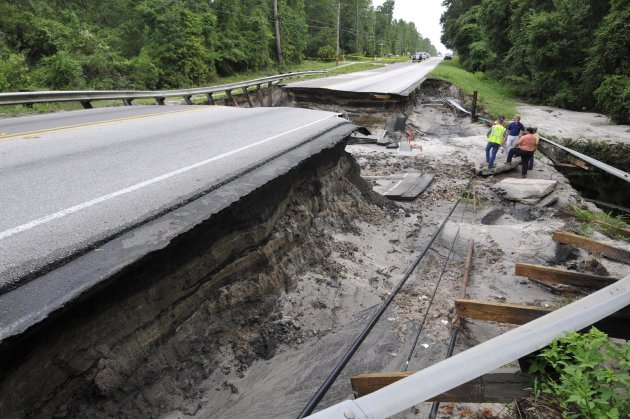 Clay County engineers and contractors inspect CR 218 west of Middleburg, Fla. Wednesday, June 27, 2012, after the road washed out overnight. Heavy rains from Tropical Storm Debby were the cause of the