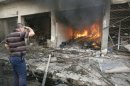 An Iraqi man looks at a fire inside a store following a car bomb in Kirkuk
